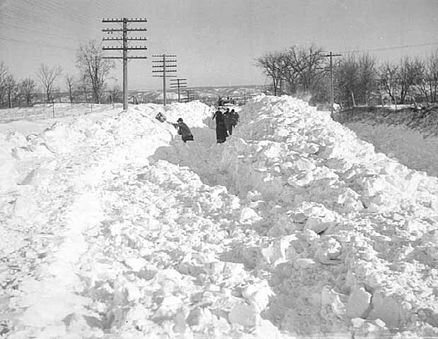 Snowplow and men with shovels attempting to clear road after the Armistice Day blizzard.
Source:  Minnesota Historical Society